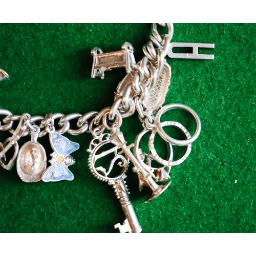 47 - Silver Charm Bracelet Adorned with Various Charms Safety Chain and Padlock Motif Clasp Present
