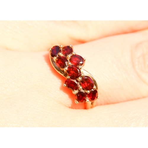 10 - Nine Stone Red Garnet Set Cluster Ring Mounted in 9 Carat Yellow Gold Ring Size P