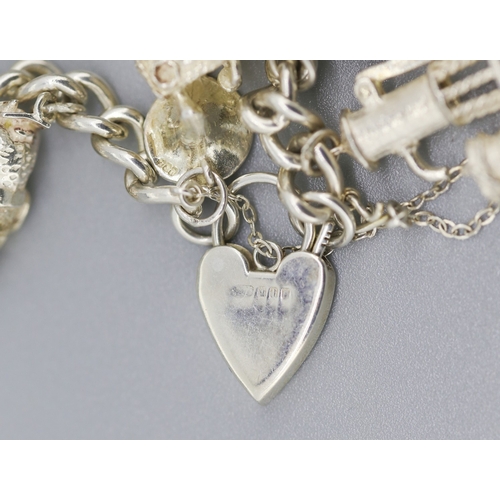 111 - Silver Charm Bracelet with Eleven Charms Heart Padlock Clasp and Safety Chain 18.5cm Long
