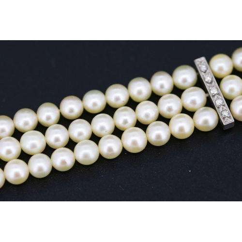 12 - Platinum Mounted Diamond Set Three Strand Pearl Bracelet 18cm Long