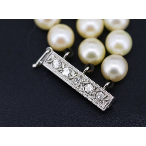 12 - Platinum Mounted Diamond Set Three Strand Pearl Bracelet 18cm Long