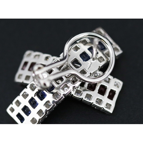 13 - Pair of Attractively Detailed Baguette Cut Ruby, Sapphire and Round Cut Diamond Set Cross Over Earri... 