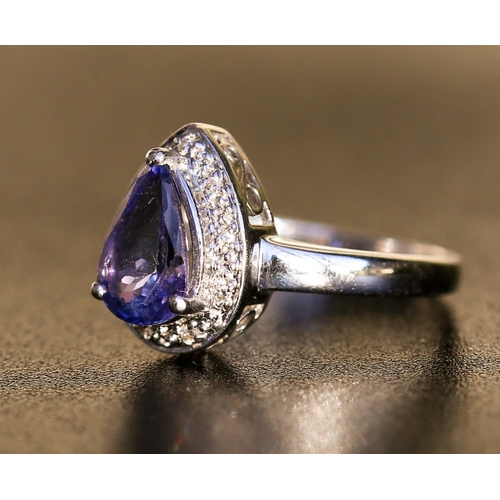 25 - Pear Cut Tanzanite Set Ring with Diamond Inset Surround Mounted in 18 Carat White Gold Ring Size O a... 