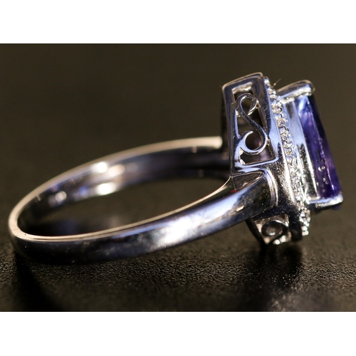 25 - Pear Cut Tanzanite Set Ring with Diamond Inset Surround Mounted in 18 Carat White Gold Ring Size O a... 