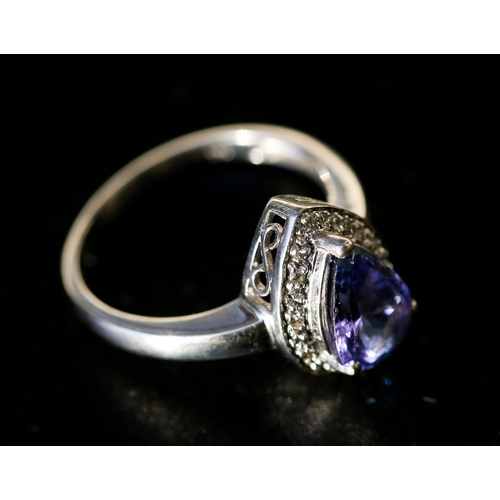 25 - Pear Cut Tanzanite Set Ring with Diamond Inset Surround Mounted in 18 Carat White Gold Ring Size O a... 