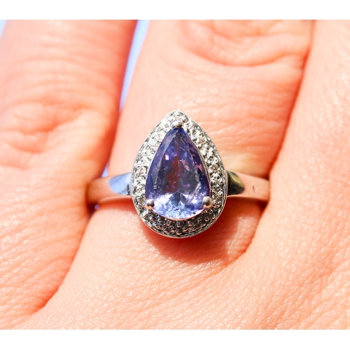 25 - Pear Cut Tanzanite Set Ring with Diamond Inset Surround Mounted in 18 Carat White Gold Ring Size O a... 