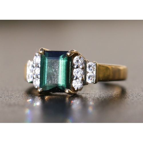 26 - Emerald Cut Deep Green Tourmaline Set Ring with Five Stone Diamonds Set to Each Shoulder Mounted in ... 