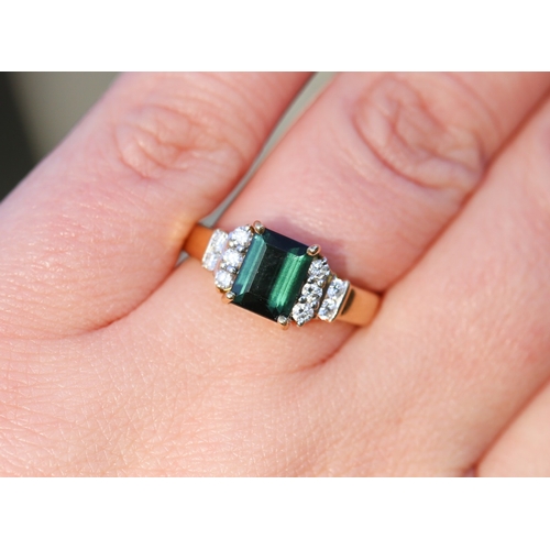 26 - Emerald Cut Deep Green Tourmaline Set Ring with Five Stone Diamonds Set to Each Shoulder Mounted in ... 