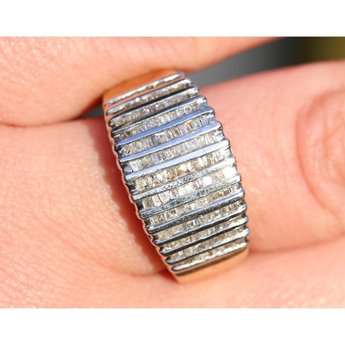 28 - Channel Set Tapered Baguette Cut Diamond Multi Row Cluster Ring Mounted in 10 Carat Yellow Gold Ring... 