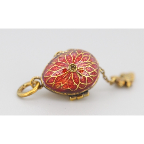 289 - Enamel Decorated Russian Silver Gilt Egg Pendant with Hidden Angel Drop Charm 2cm