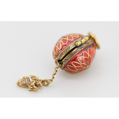 289 - Enamel Decorated Russian Silver Gilt Egg Pendant with Hidden Angel Drop Charm 2cm
