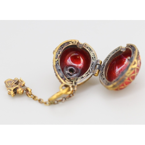 289 - Enamel Decorated Russian Silver Gilt Egg Pendant with Hidden Angel Drop Charm 2cm