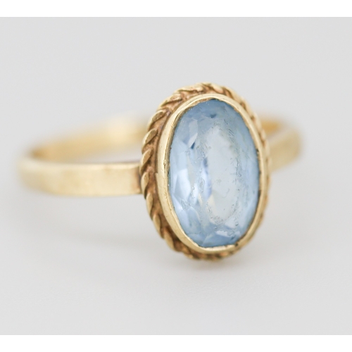302 - Aquamarine Bezel Set Single Stone Ring Mounted in 9 Carat Yellow Gold Ring Size O and a Half