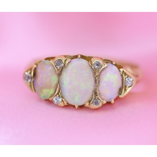 64 - Opal Three Stone Ring with Further Diamond Insets Mounted in 18 Carat Yellow Gold Ring Size O