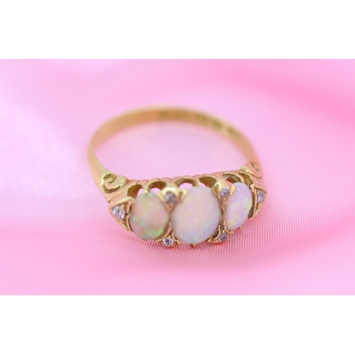 64 - Opal Three Stone Ring with Further Diamond Insets Mounted in 18 Carat Yellow Gold Ring Size O