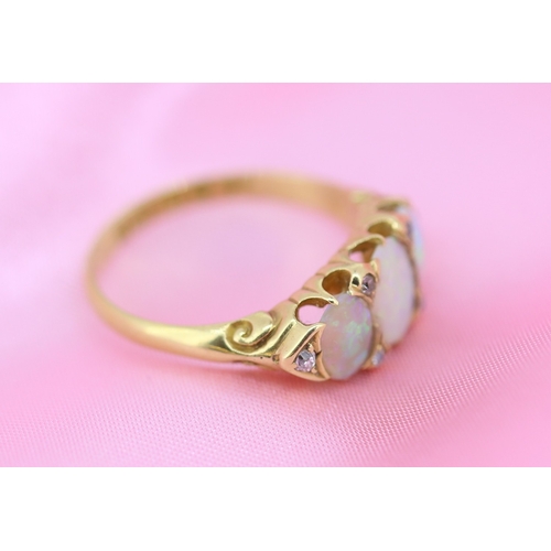 64 - Opal Three Stone Ring with Further Diamond Insets Mounted in 18 Carat Yellow Gold Ring Size O