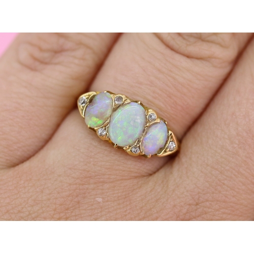 64 - Opal Three Stone Ring with Further Diamond Insets Mounted in 18 Carat Yellow Gold Ring Size O
