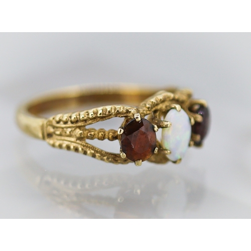 16 - Opal and Red Garnet Set Ring Attractively Detailed Mounted in 9 Carat Yellow Gold Ring Size O