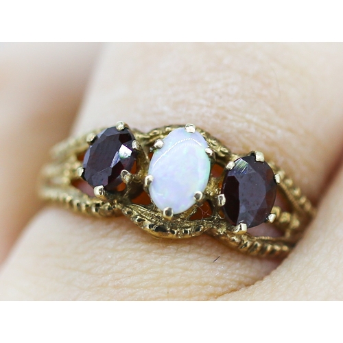 16 - Opal and Red Garnet Set Ring Attractively Detailed Mounted in 9 Carat Yellow Gold Ring Size O