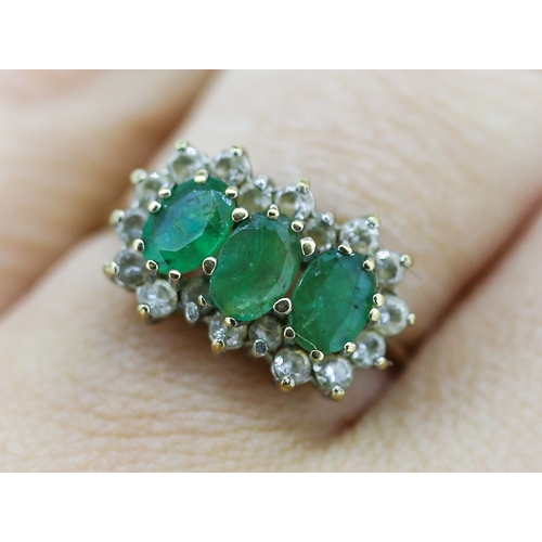 18 - Emerald Three Stone Ring with Gemset Cluster Surround Mounted in 9 Carat Yellow Gold Ring Size O