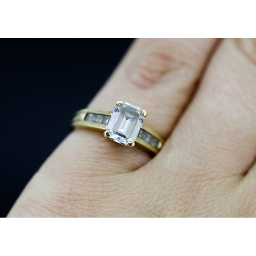 30 - Emerald Cut Cubic Zirconia Set Ring with Further Gemstone Set to Shoulders Mounted in 9 Carat Yellow... 
