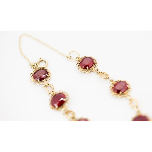 31 - Finely Detailed Cherry Garnet Seven Stone Set Bracelet Mounted in 9 Carat Yellow Gold with Safety Ch... 