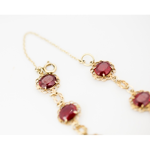 31 - Finely Detailed Cherry Garnet Seven Stone Set Bracelet Mounted in 9 Carat Yellow Gold with Safety Ch... 