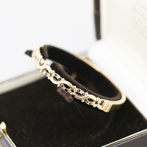 41 - Attractively Detailed Sapphire Set Bangle Bracelet Mounted in 9 Carat Yellow Gold Inner Width 6cm