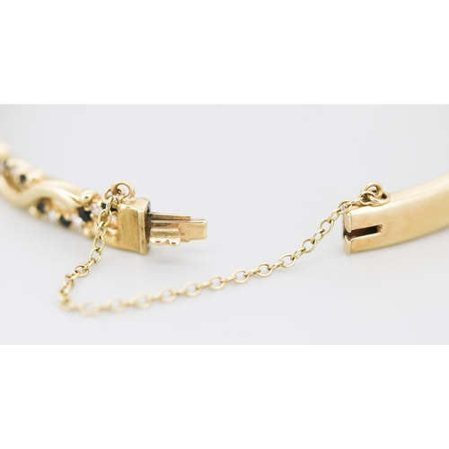 41 - Attractively Detailed Sapphire Set Bangle Bracelet Mounted in 9 Carat Yellow Gold Inner Width 6cm