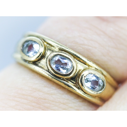 8 - Aquamarine Bezel Set Three Stone Ring Mounted in 9 Carat Yellow Gold Ring Size L