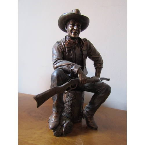 13 - Bronzed Figure John Wayne Seated with Rifle and Stetson Attractively Modelled Approximately 9 Inches... 
