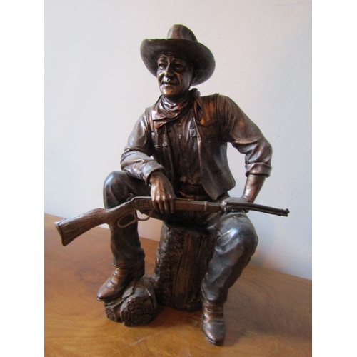 13 - Bronzed Figure John Wayne Seated with Rifle and Stetson Attractively Modelled Approximately 9 Inches... 