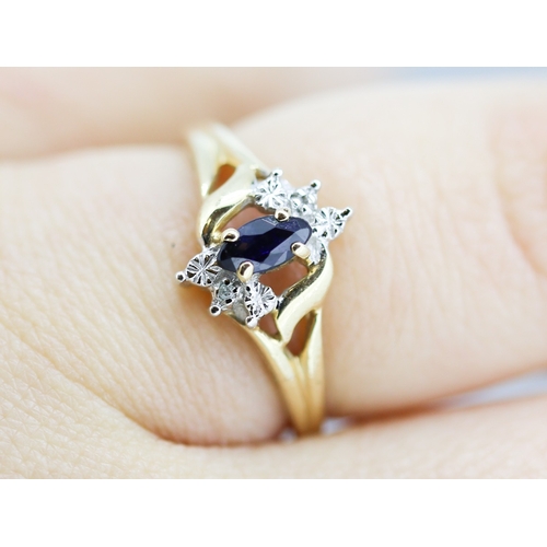 16 - Attractively Detailed Marquise Cut Sapphire Set Ring with Diamond Inset Mounted in 10 Carat Yellow G... 