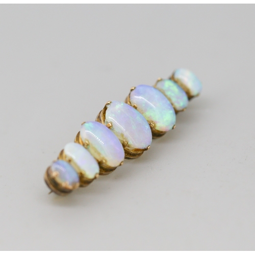 45 - Opal Seven Stone Graduated Form Brooch Mounted in 9 Carat Yellow Gold 4cm