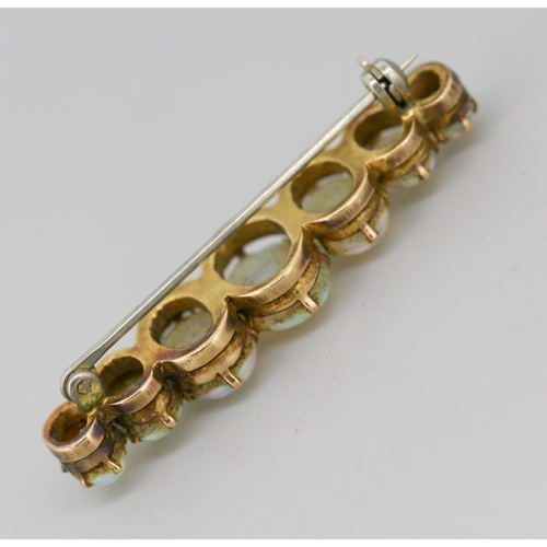 45 - Opal Seven Stone Graduated Form Brooch Mounted in 9 Carat Yellow Gold 4cm