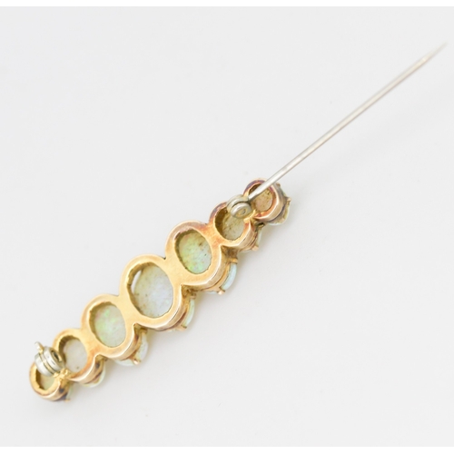 45 - Opal Seven Stone Graduated Form Brooch Mounted in 9 Carat Yellow Gold 4cm