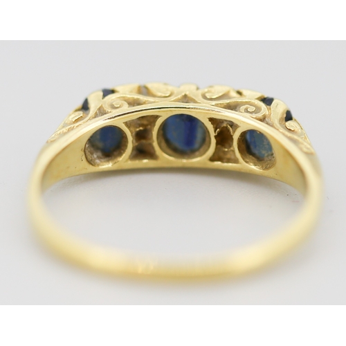 57 - Sapphire Three Stone Ring with Six Diamond Inset Mounted in 18 Carat Yellow Gold Ring Size P