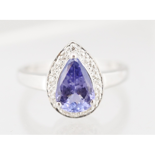 30 - Pear Cut Tanzanite Set Ring with Diamond Set Surround Mounted in 18 Carat White Gold Ring Size P