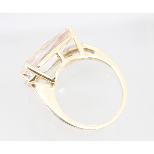 57 - Pear Cut Morganite Set Ring with Diamond Set Surround Mounted in 9 Carat Yellow Gold Ring Size L