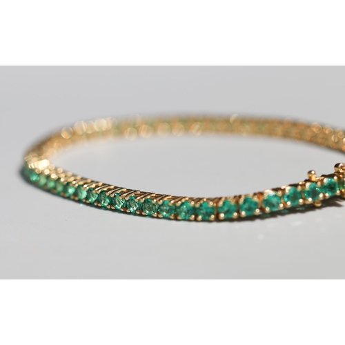 53 - Emerald Fifty-Six Stone Set Tennis Bracelet, Mounted in 18 Carat Yellow Gold, Total Emerald Carat We... 
