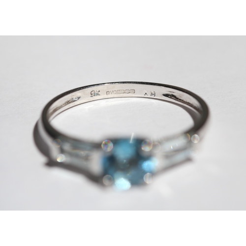 15 - Blue Topaz Set Ring with Tapered Baguette Cut Aquamarine Set to Shoulders, Mounted in 9 Carat White ... 