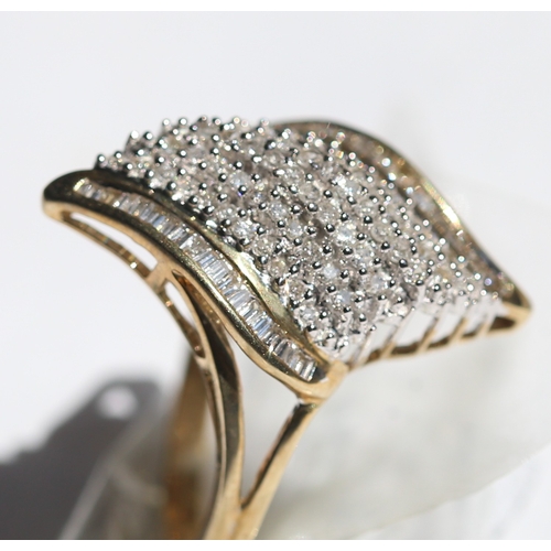 16 - Finely Detailed Round Cut and Tapered Baguette Cut Diamond Set Cluster Ring, Mounted in 9 Carat Yell... 