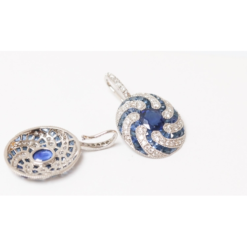25 - Pair of Finely Detailed Sapphire Centre Stone Set Earrings with Diamond and Sapphire Swirl Motif Set... 