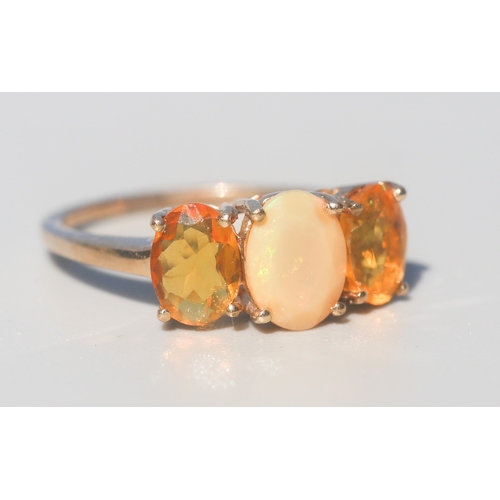 17 - Opal and Ethiopian Opal Set Three Stone Ring, Mounted in 9 Carat Yellow Gold, Ring Size N and a Half