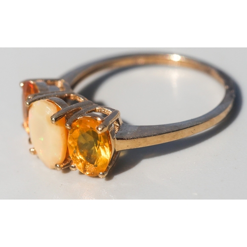 17 - Opal and Ethiopian Opal Set Three Stone Ring, Mounted in 9 Carat Yellow Gold, Ring Size N and a Half