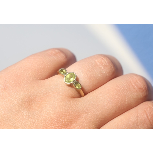 24 - Bezel Set Peridot Three Stone Ring, Mounted in 9 Carat Yellow Gold, Ring Size O and a Half
