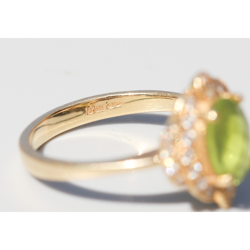 30 - Finely Detailed, Facet Cut Peridot Set Centre Stone Ring with Diamond Cluster Set Surround, Mounted ... 