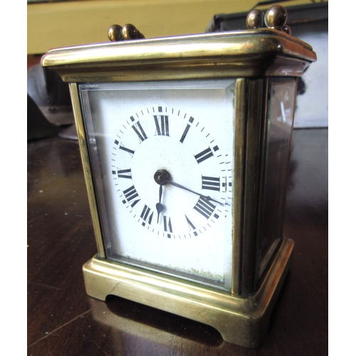 Antique Brass Bound Carriage Clock with Swing Carry Handle Roman Numeral Decorated Dial Approximately 5 Inches High