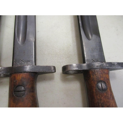 100a - Australian Lithgow 1907 Pattern SMLE bayonets and leather scabbards with:
1. 1920, ricasso marked 19... 