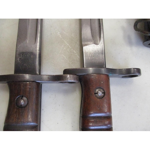 96 - US & GB bayonet and leather scabbard range with:
1. 1942 Wilkinson 1907 Pattern, ricasso marked crow... 